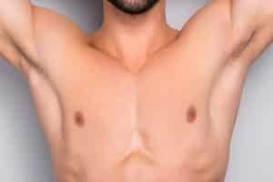 Attractive, Stunning, Manly, Smiling Macho Isolated On Gray Background, Having Two Arms Behind The Head And Closed Eyes, Showing His Shaven Armpits – Wellness, Wellbeing Concept Gyne Feat