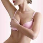 Young Caucasian Adult Woman Wearing Pink Bra Examining Her Breast
