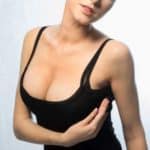 Woman Wearing Black Undergarments Lifting Her Breast