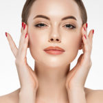 Woman beauty healthy clean skin, hand touching face