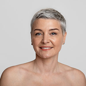 Beauty Portrait Of Smiling Nude Middle Aged Woman With Short Haircut